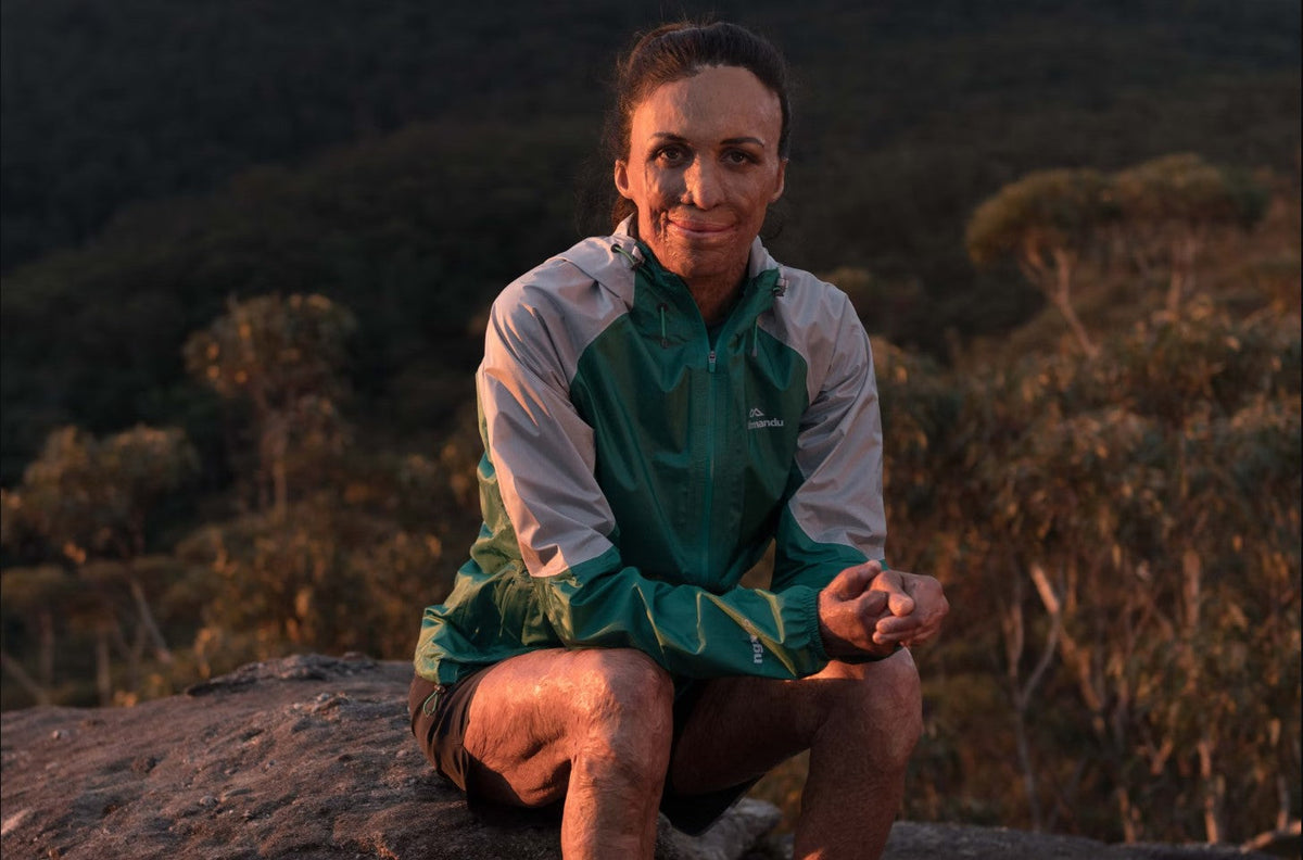 Turia Pitt sitting outside in the australian bush