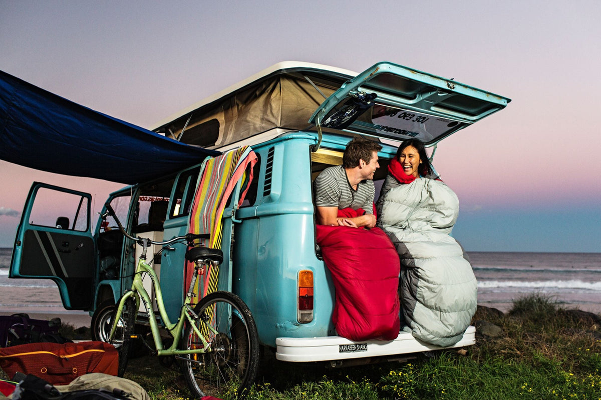 Two campers wrapped in their sleeping bags in Byron Bay.