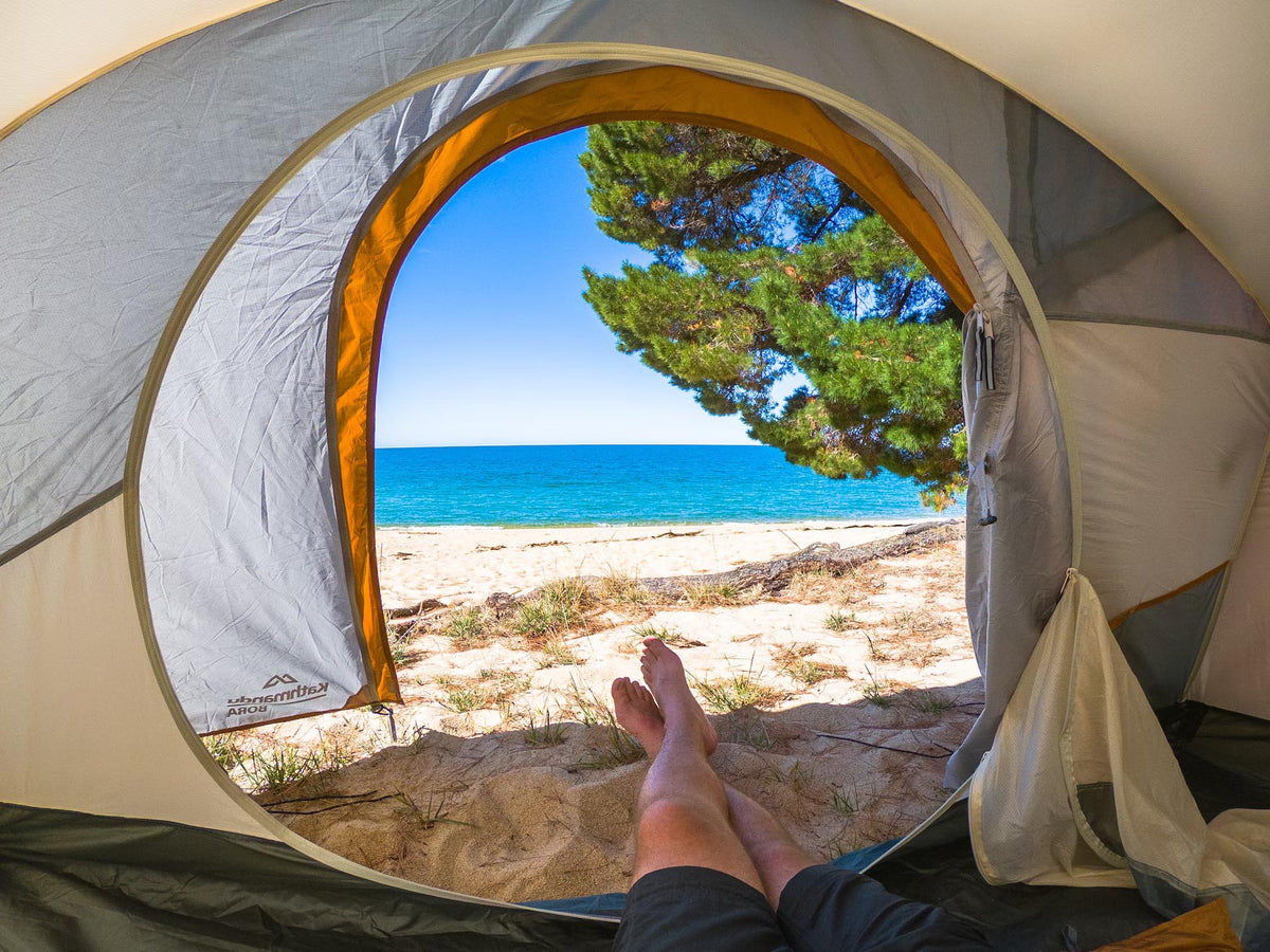 Pitching your tent along the Abel Tasman Track in New Zealand to wake up surrounded by beautiful beaches.