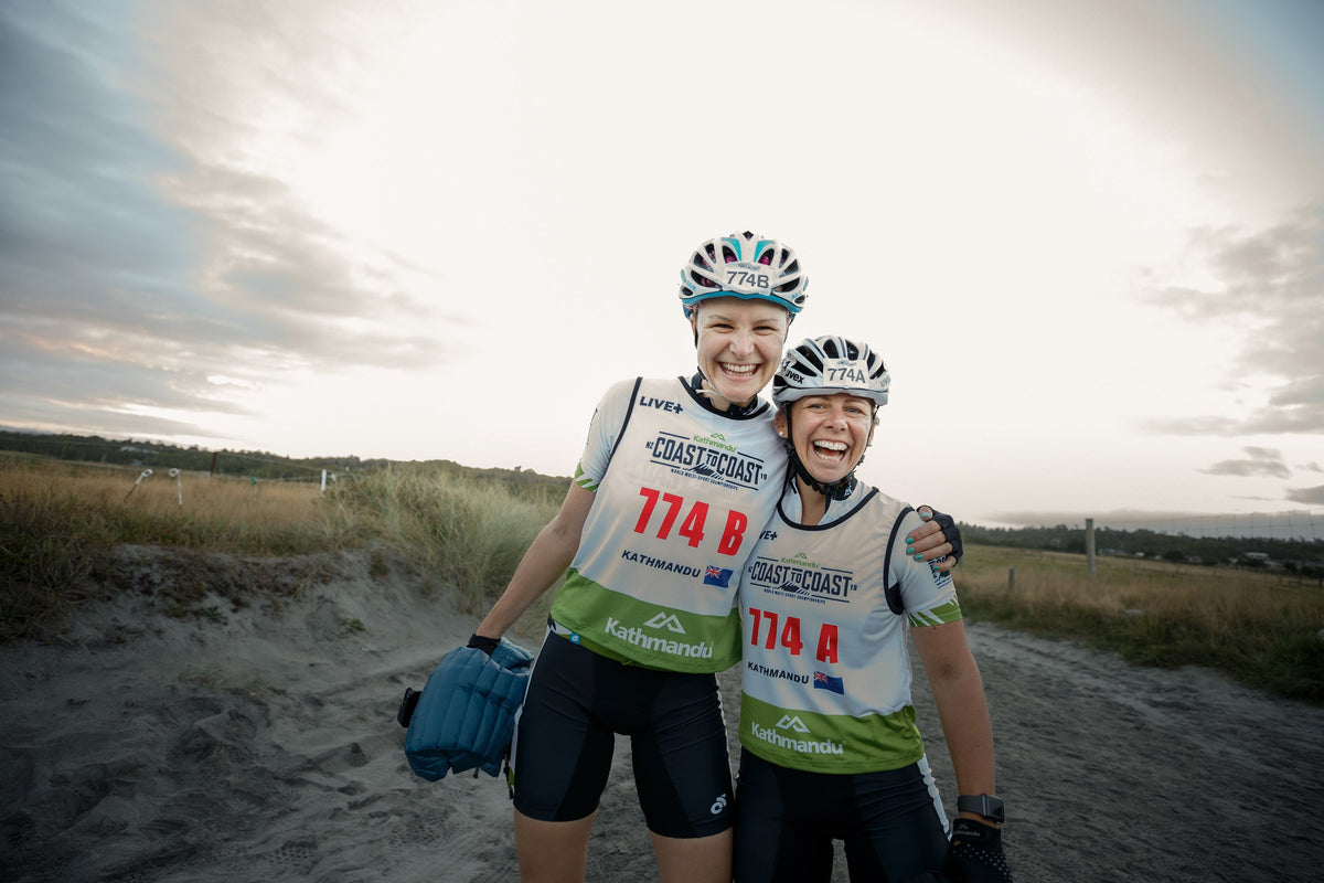 UK Adventurer Anna McNuff and NZ Endurance Athlete Hollie Woodhouse smiling at the start of Kathmandu Coast to Coast.