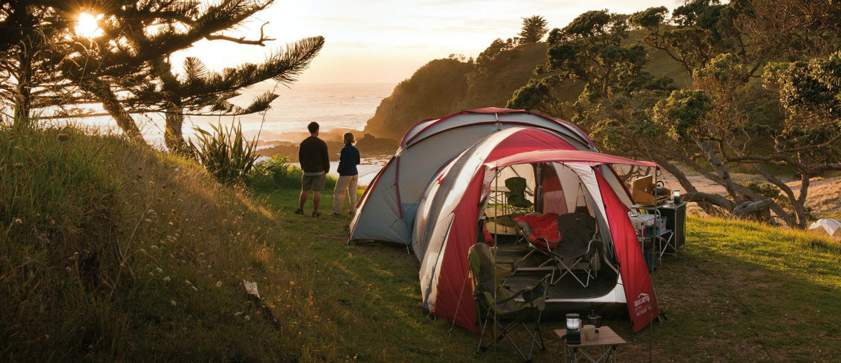 Sunset at a campsite looking into a fully set up family tent.