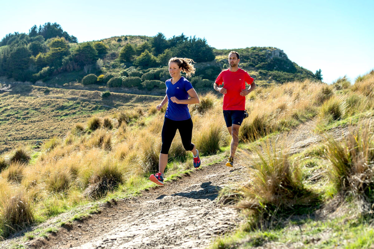 A couple is enjoying a gentle trail run on a sunny day
